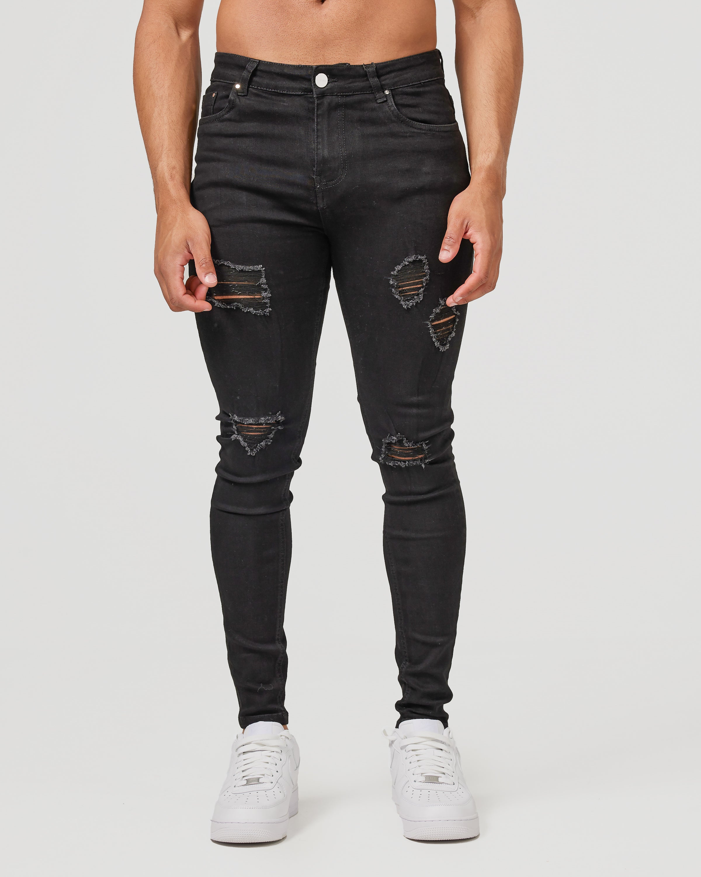 Jeans skinny noirs déchirés - denim usé et audacieux avec coupe slim